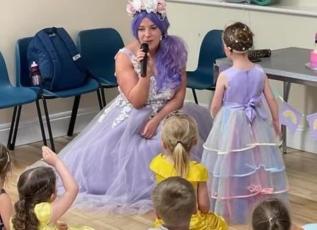 Princess entertainer singing with children