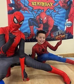 Superhero entertainer with a birthday child